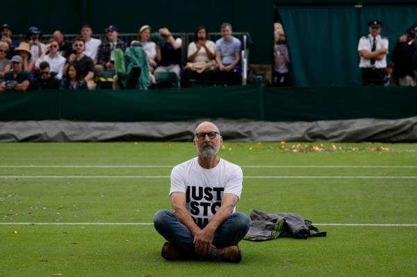 A Just Stop Oil protester sits on Court 18 on day three of the Wimbledon tennis champio<em></em>nships in London, on July 5, 2023.