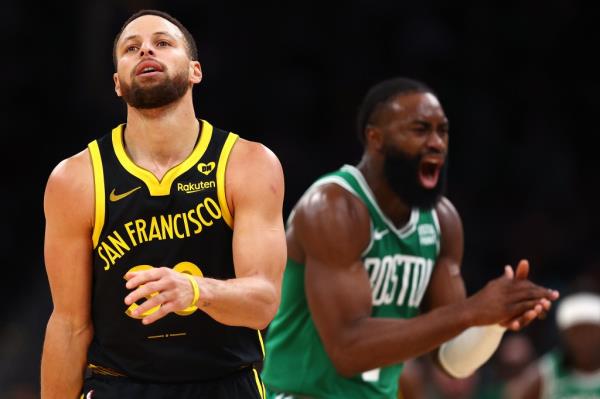 Jaylen Brown celebrates next to Stephen Curry during the second quarter at TD Garden on March 3, 2024.