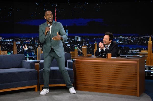 Jay Pharoah standing in front of Jimmy Fallon. 