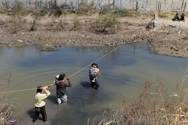 Migrants seeking asylum in the United States cross the Rio Bravo on the border of Ciudad Juarez, Chihuahua state, Mexico on March 19, 2024. 