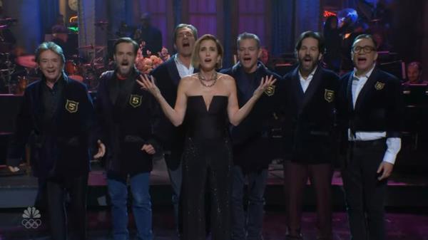 Exasperated, Wiig turns to Michaels and demands an explanation but finds that the 
