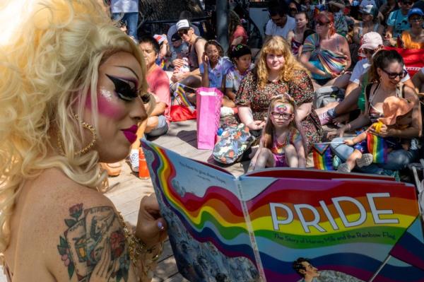 drag queen Brigitte Bandit reads a book during a drag time story hour at the Waterloo Greenway park on June 10, 2023 in Austin, Texas.