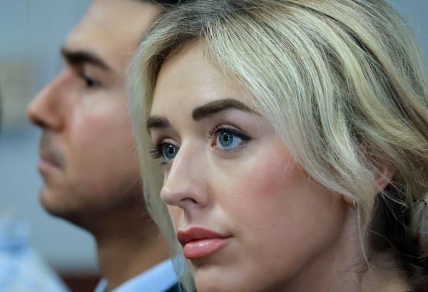 Nilo waits with his girlfriend before new charges are read.