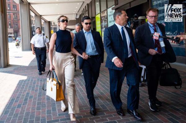 Matthew Nilo and his fiancee, Laura Griffin, walk hand-in-hand after leaving Suffolk County Court in Boston