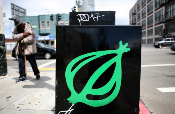 A pedestrian walks by an o<em></em>nion news rack May 5, 2009 in San Francisco