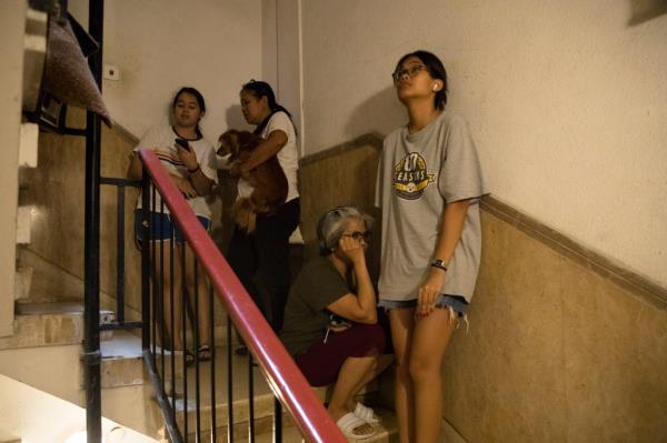 A photo of Israeli citizens  cowering in a stairwell during the Hamas attack.