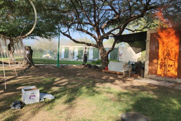 A house is on fire in the kibbutz of Kfar Azza that Palestinians stormed from the Gaza Strip on Saturday.