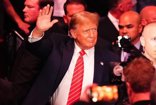 Trump waves to the crowd as he enters the Kaseya Center for UFC 299 on March 9, 2024. 