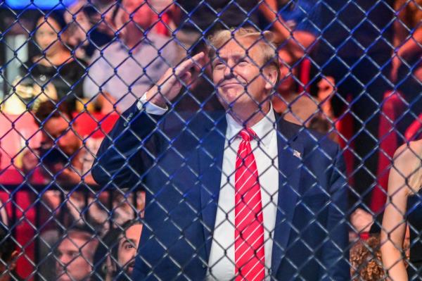 Trump gives a salute during UFC 299 on Saturday night.
