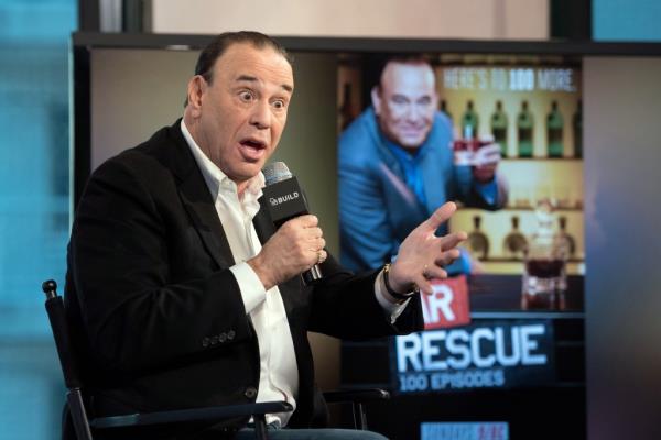 jon taffer speaking into a microphone while sitting in a chair
