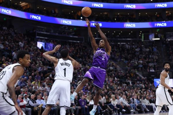 Utah Jazz guard Collin Sexton (2) shoots the ball over Brooklyn Nets forward Mikal Bridges.