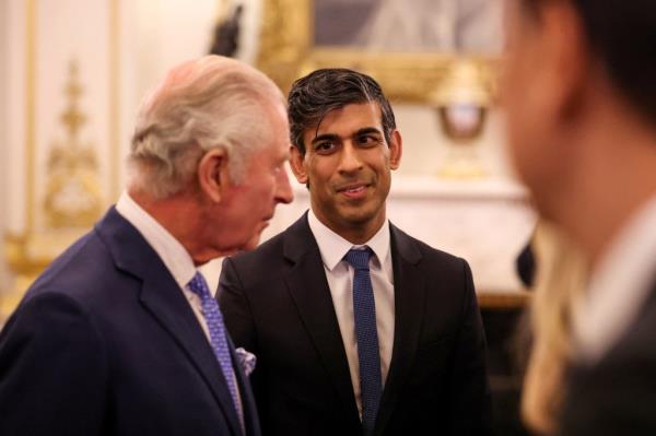 Britain's Prime Minister Rishi Sunak reacts as he attends a reception at Buckingham Palace, in central London, on November 27, 2023