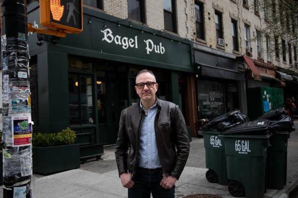 Ted Rao standing in front of Bagel Pub in Brooklyn, New York, voicing co<em></em>ncerns a<em></em>bout the handling of leftover bagels.