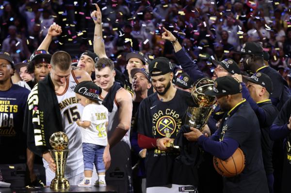 Nikola Jokic is presented with the Bill Russell Finals MVP Trophy while Jamal Murray holds the Larry O'Brien Champio<em></em>nship Trophy after Game Five of the 2023 NBA Finals on June 12, 2023 at Ball Arena in Denver, CO. 