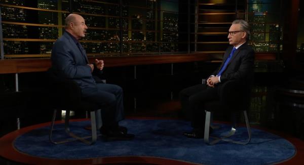 Dr. Phil McGraw and Bill Maher in suits sitting in chairs.
