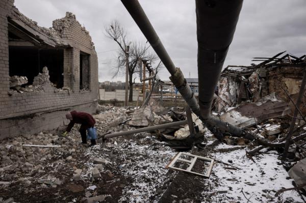 Nadezhda Prokopenko clears debris in the yard of the house of a relative that was destroyed in a Russian missile strike, amid Russiaas attack on Ukraine, in Selydove near Avdiivka, Ukraine, February 19, 2024. 