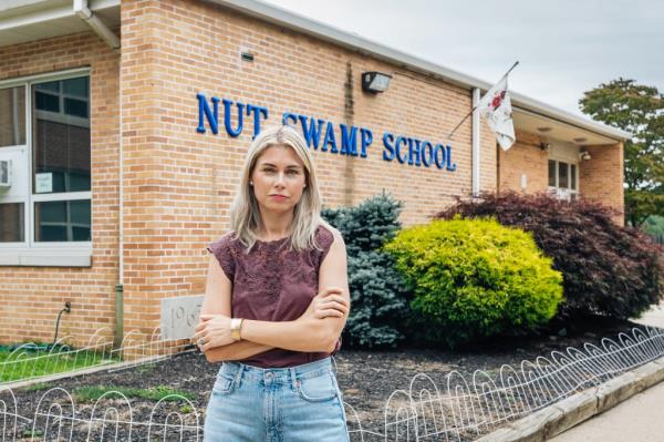 Mother of two, Laura Abt stands outside of her children's school. 