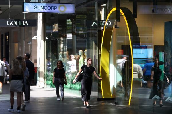 SYDNEY, AUSTRALIA - FEBRUARY 26: Pedestrians walk past a Suncorp Group Ltd. branch in Sydney on February 26, 2024 in Sydney, Australia. The recent approval by the Australian Competition Tribunal of ANZ's A$4.9 billion ($3.2 billion) acquisition of Suncorp's banking business marks a major development in the country's financial landscape, signaling the largest banking merger since the global financial crisis. (Photo by Lisa Maree Williams/Getty Images)