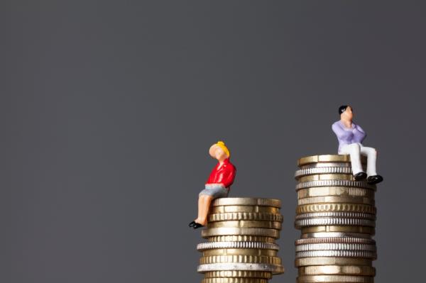 Gender pay equality concept. man and woman on a stack of coins.