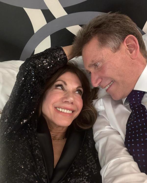 Gerry Turner and Theresa Nist from 'Golden Bachelor' lying on a bed after their televised wedding ceremony