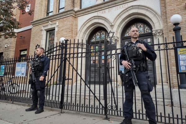 Hoboken Police officers standing guard outside the United Synagogue of Hoboken in respo<em></em>nse to a potential threat