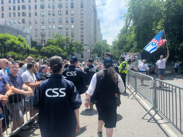 A group of people, including CSS volunteers and law enforcement, providing security at the Israel Day Parade in Manhattan.