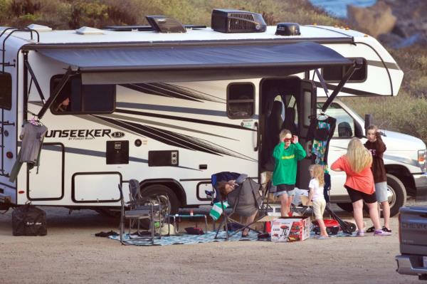 Spelling and her family lingering near their mobile home. 