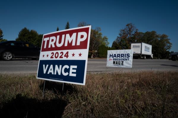 Signs showing support for both Democratic presidential candidate Vice President Kamala Harris and Republican presidential candidate former President Do<em></em>nald Trump sit along a rural highway on September 26, 2024 near Traverse City, Michigan