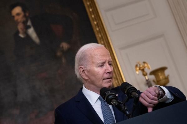 President Joe Biden checks his watch as he arrives to speak a<em></em>bout the situation in the Middle East.