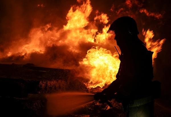Firefighter works at site of Russian drone strike in Kharkiv, Ukraine.