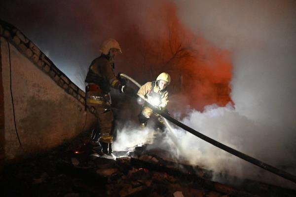 Firefighters work to extinguish a fire caused by the Russian drone strike late Friday night in Kharkiv, Ukraine.