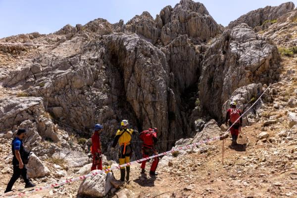 Rescue workers wearing helmets and exploration gear at the entrance to the Morca cave system in Turkey.