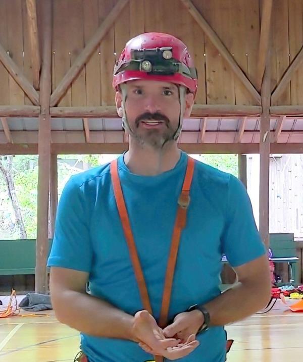 Mark Dickey, 40, wearing a helmet and safety gear, looking at the camera.