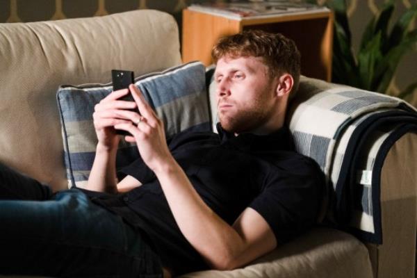 Jay on his phone in EastEnders
