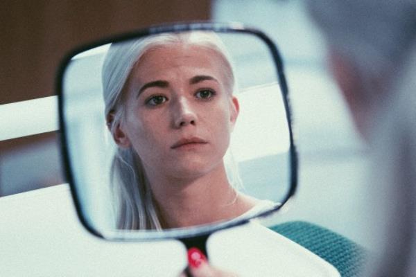 EastEnders picture shows Lola Pearce-Brown (played by Danielle Harold) sharing at her reflection in a mirror at the hospital ahead of surgery