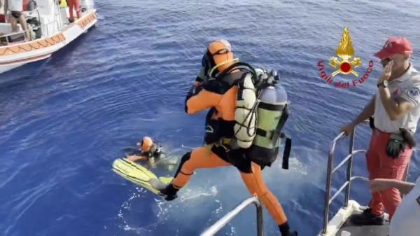 Divers jump into the waters looking for the missing people after the storm struck the yacht.