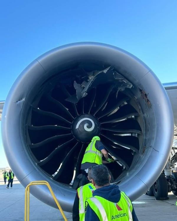 Bits of steel could be seen stuck in the plane's engine as American Airline crews inspected the damage. 