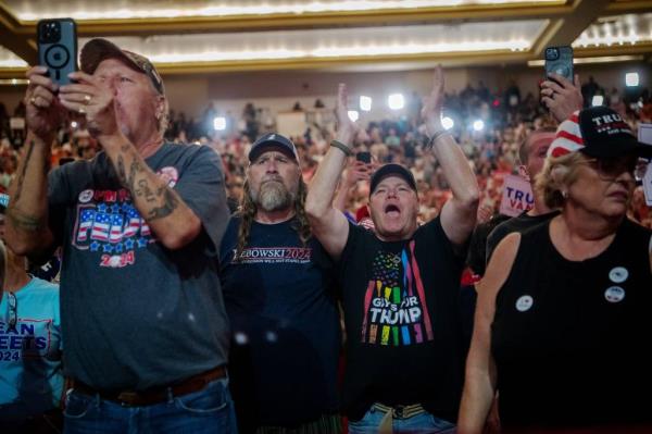 Supporters of Republican presidential candidate Do<em></em>nald Trump reacting as he takes the stage at Thomas Wolfe Auditorium in Asheville, August 14, 2024.