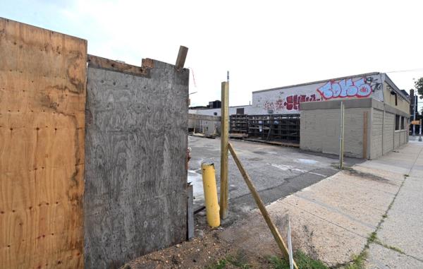 A picture shows the lot today, and the debris pile mostly gone.
