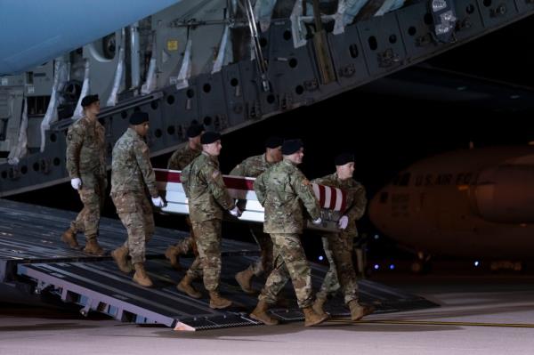 An Army carry team moves the transfer case co<em></em>ntaining the remains of Sgt. Andrew P. Southard at Dover Air Force ba<em></em>se, Del., Tuesday, Nov. 14, 2023. 
