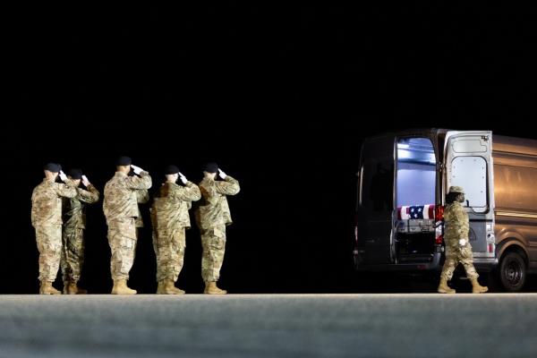 Soldiers salute the remains of Army Staff Sgt. Tanner W. Grone and Army Sgt. Andrew P. Southard at Dover Air Force ba<em></em>se on Nov. 14, 2023 in Dover, Delaware.