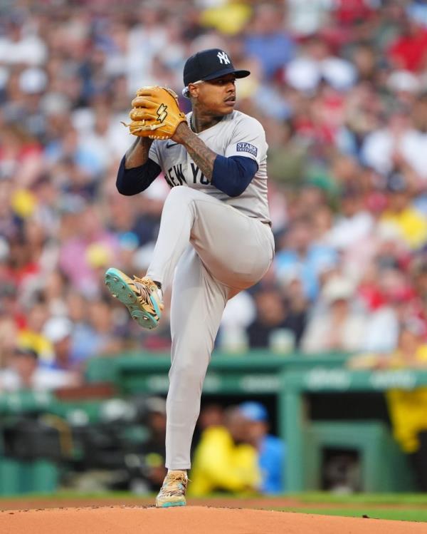 New York Yankees pitcher Marcus Stroman delivering a pitch against the Boston Red Sox at Fenway Park