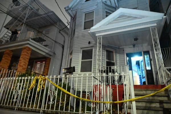 A white house in Cypress Hills with caution tape.