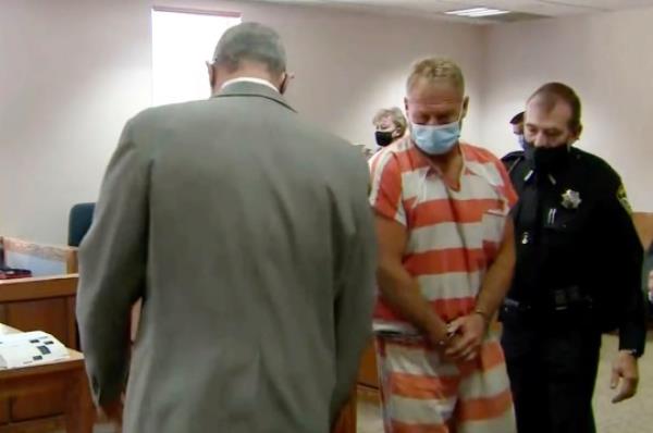 Barry Morphew (center) was arrested in co<em></em>nnection with the disappearance of his wife and faced multiple charges including first-degree murder