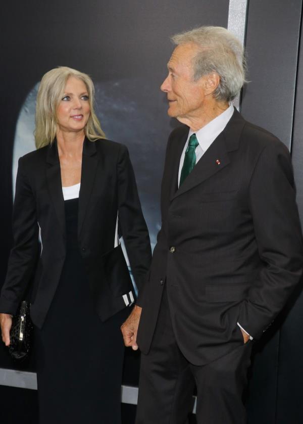 Clint Eastwood and Christina Sandera posing for photos at the