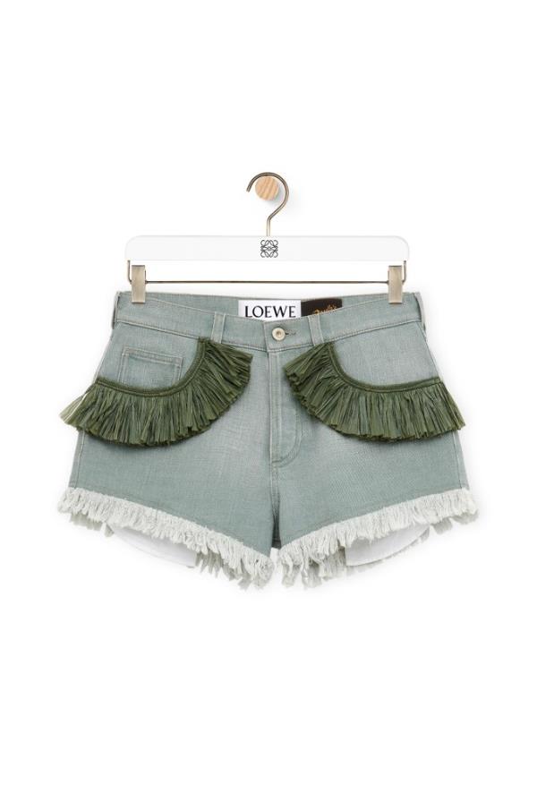 A pair of khaki green, fringe denim shorts priced at $990.00