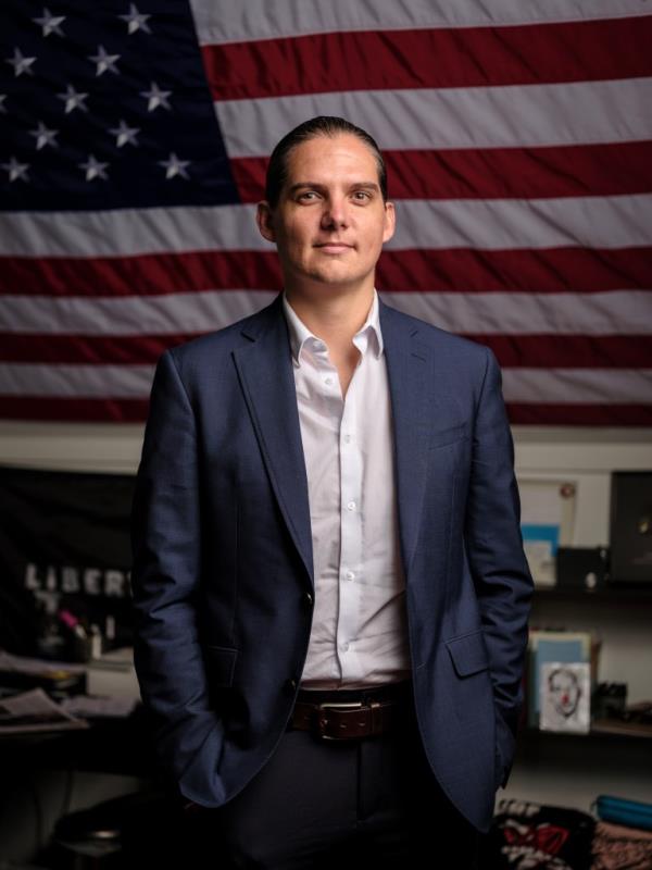 Robby Starbuck in front of an American flag