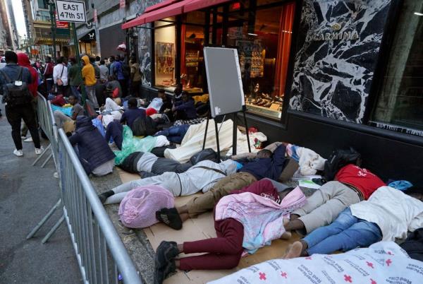 Migrants sleeping outside of the shelter at the Roosevelt Hotel on August 1, 2023.