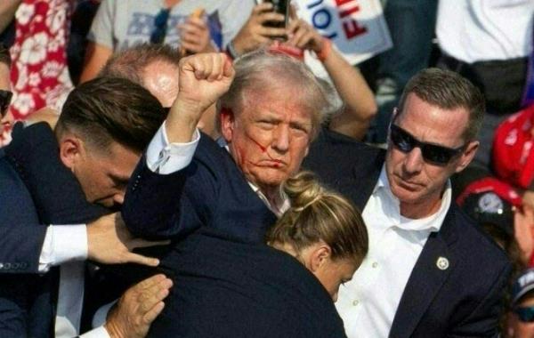 Republican candidate Do<em></em>nald Trump is seen with blood on his face surrounded by secret service agents as he is taken off the stage at a campaign event at Butler Farm Show Inc. in Butler, Pennsylvania, July 13, 2024.