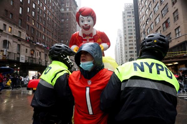 Police officers detain protesters during the 98th Macy's Thanksgiving Day Parade in New York City, U.S., November 28, 2024. 